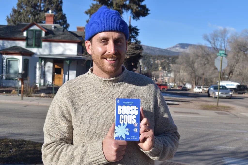 Boostcous co-founder Bar Bruhis with boxes of the high-protein couscous product.